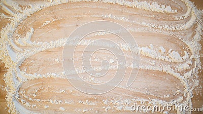 Flour smoothed across a wooden cutting board Stock Photo