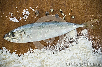 Floury fish on a wooden background Stock Photo