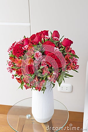 Flower arrangement of red roses in a nice living room Stock Photo