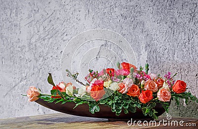 Flower arrangement in wooden tray Stock Photo