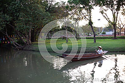 Flower boat and boat with man in Suan Luang Rama IX Flowers Festival Editorial Stock Photo