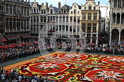 Brussels, Belgium - Flower carpet and crowded Grand Place, architecture behind Editorial Stock Photo