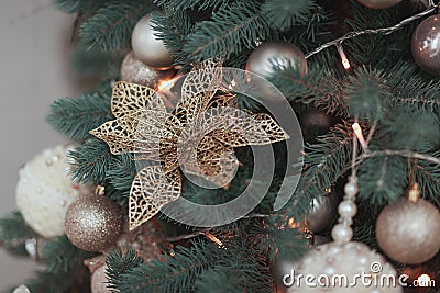 Flower Christmas tree Decoration, Gold Glossy Ornament Set, hanging on fir with balls and garland Stock Photo