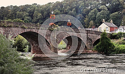 Flower decked bridge over the River Usk Stock Photo