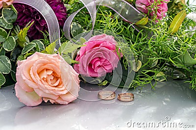 Flower decoration and a ring set on gray wedding car bonnet. Stock Photo