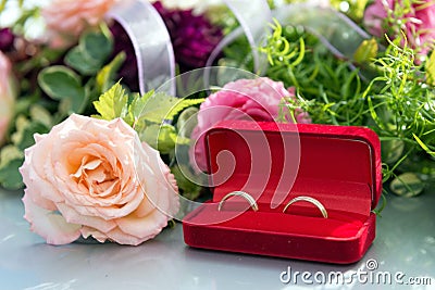 Flower decoration and a ring set on gray wedding car bonnet. Stock Photo