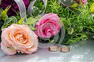 Flower decoration and a ring set on gray wedding car bonnet. Stock Photo