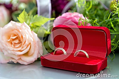 Flower decoration and a ring set on gray wedding car bonnet. Stock Photo