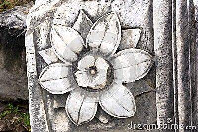 Flower engraved on marble stone, antique stone block, stone flower Stock Photo