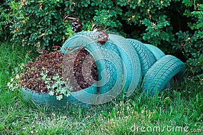 A flower in the form of a frog made of used automobile tires Stock Photo