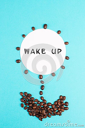Flower made with coffee beans, the words wake up are standing on the blossom, good morning, having an espresso for breakfast Stock Photo