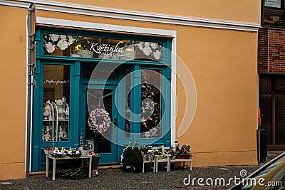 Flower shop with cozy blue showcase, Christmas decorations, Kolin in autumn day, Central Bohemia, Czech Republic Editorial Stock Photo