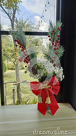 Flower vase decorated with red ribbon on Christmas Day Stock Photo
