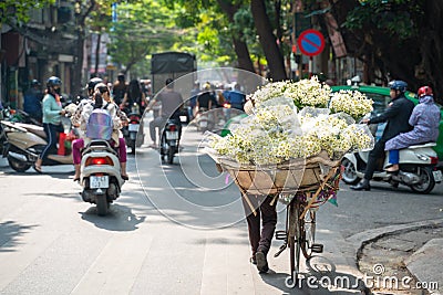 Flower vendor on Hanoi old town street at early morning Editorial Stock Photo