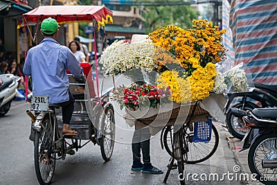 Flower vendor on Hanoi old town street at early morning Editorial Stock Photo