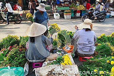 Flower vendors at the Hoi An market in Hoi An Ancient Town, Quang Nam, Vietnam. Editorial Stock Photo