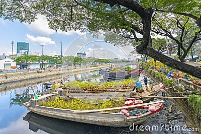 Flowers boats at flower market on along canal wharf Editorial Stock Photo