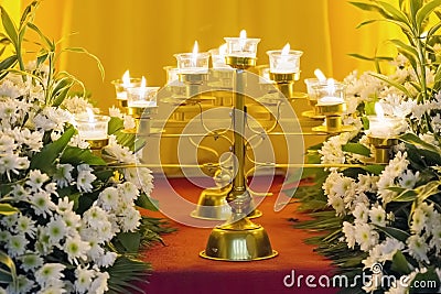 Flowers and Burning Candles Stock Photo