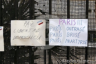 Flowers, candles and signs against terrorist attack in Paris, placed in front of French embassy in Madrid, Spain Editorial Stock Photo