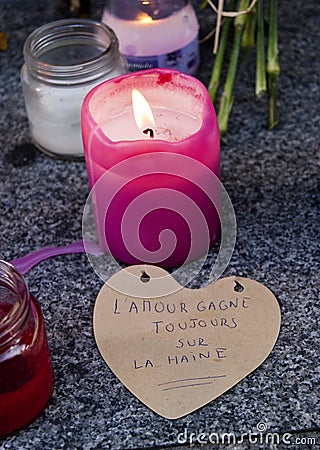 Flowers, candles and signs against terrorist attack in Paris, placed in front of French embassy in Madrid, Spain Editorial Stock Photo