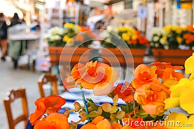 Flowers decorate the outdoor cafe on the market in Venice Stock Photo