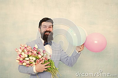 Flowers delivery. Gentleman romantic date. Birthday greetings. For someone special. Man bearded gentleman suit bow tie Stock Photo