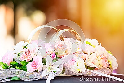 Flowers and golden rings wedding ornament decoration on a car limousine. Toned. Stock Photo