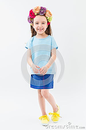 Flowers head accessory blue t-shirt navy skirt yellow sneakers casual style. Stock Photo