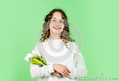 Flowers for her. international childrens day. mothers day concept. cheerful little girl with curly hair. tulips flowers Stock Photo