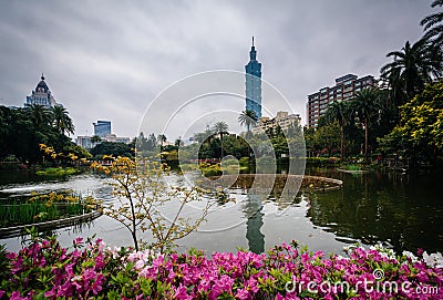 Flowers, lake, and Taipei 101 at Zhongshan Park, in the Xinyi Di Stock Photo