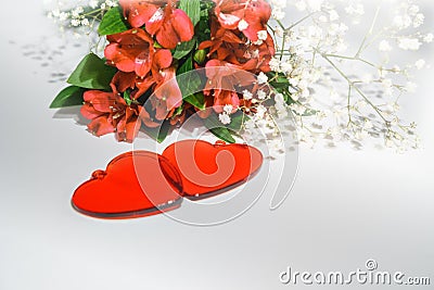 Flowers lily in color of the year 2019 - Living Coral. Livingcoral. Romantic bouquet and two red hearts for Valentines day dinner Stock Photo