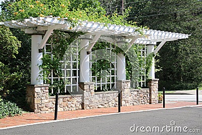 The flowers and plants are growing by the trellis. Stock Photo