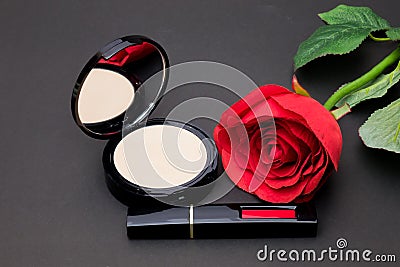 Flowers rose,Powder and lipstick brush uses lips on black backg Stock Photo