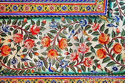 Flowers and small birds design on colorful fresco of historical mansion Stock Photo