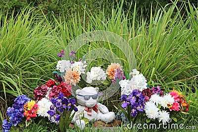 Flowers and stuffed bear memorial tribute at the park Stock Photo