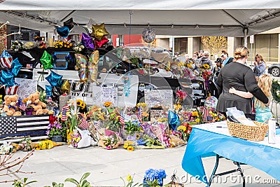 Flowers, teddy bears and messages of love spill over a squad car in Everett. Editorial Stock Photo