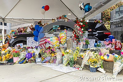 Flowers, teddy bears and messages of love spill over a squad car in Everett. Editorial Stock Photo