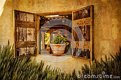 Flowers in the window of adobe style house Stock Photo