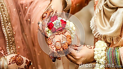 A flowery patterned band that fits the bride's hand relatively well. Stock Photo