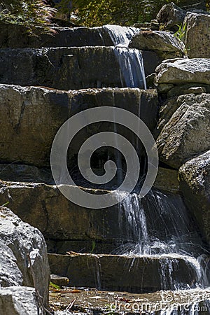 Flowing Water Over a Rock Feature Waterfall Stock Photo