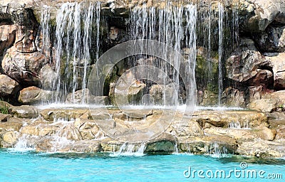 Flowing waterfall swimming pool Stock Photo