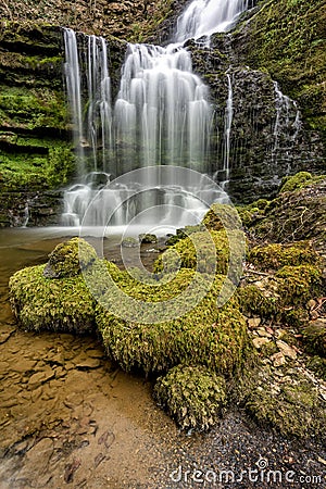 Flowing woodland waterfall. Stock Photo