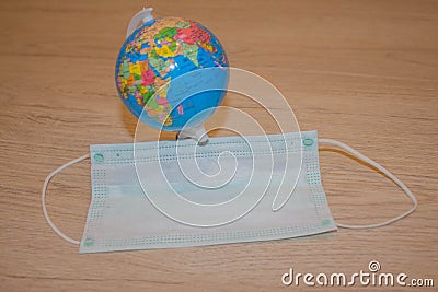 Flu and cold. Coronavirus Medical mask and globe Stock Photo