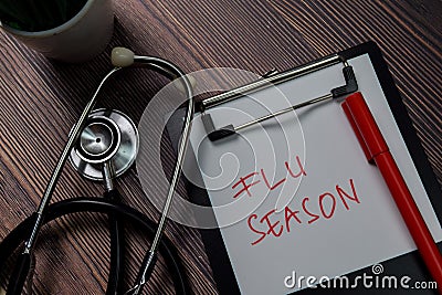 Flu Season write on paperwork isolated on wooden table Stock Photo