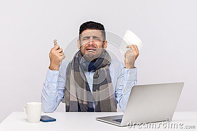 Flu-sick office worker in scarf holding pills, tissue and crying with funny expression, employee feeling unwell Stock Photo