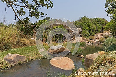 fluent river with rocks and vegetation in Africa. Lubango. Angola. Stock Photo