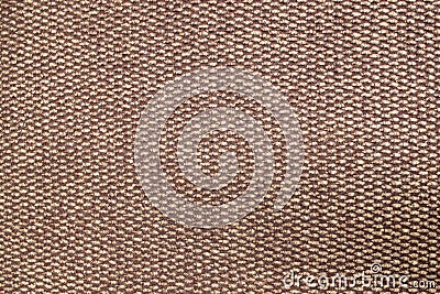 Fluffy fleecy foot rug containing a pattern of beige and brown orderly alternating woolen details of a braided pattern Stock Photo