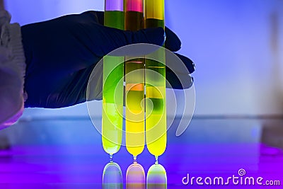 Fluorescein glowing in flask under ultraviolet ligh Stock Photo