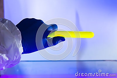 Fluorescein glowing in flask under ultraviolet ligh Stock Photo