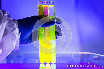 Fluorescein glowing in flask under ultraviolet light Stock Photo